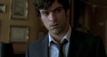Movie still from “The Beat That My Heart Skipped” (2005), directed by Jacques Audiard – A man in a black suit and a black tie; Close Up shot, Over the shoulder angle