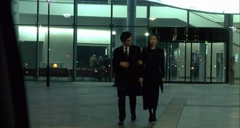 Movie still from “The Beat That My Heart Skipped” (2005), directed by Jacques Audiard – A man and a woman walking down a sidewalk; Wide shot, Low angle