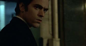 Movie still from “The Beat That My Heart Skipped” (2005), directed by Jacques Audiard – A person wearing a suit and tie; Close Up shot, Low angle