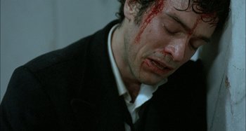 Movie still from “The Beat That My Heart Skipped” (2005), directed by Jacques Audiard – A person with blood on his face; Close Up shot, High angle