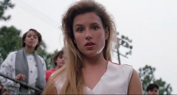 Movie still from “The Blob” (1988), directed by Chuck Russell – A woman with long blonde hair wearing a white top; Close Up shot, Low angle