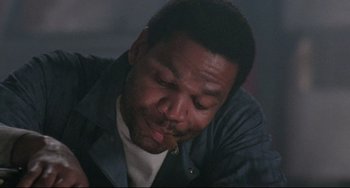 Movie still from “The Blob” (1988), directed by Chuck Russell – A person smoking a cigarette; Close Up shot, Low angle