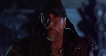 Movie still from “The Blob” (1988), directed by Chuck Russell – An old man wearing a black hat and a black jacket; Close Up shot, Low angle