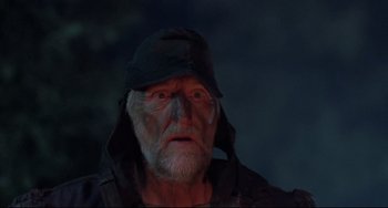 Movie still from “The Blob” (1988), directed by Chuck Russell – An old man wearing a black hat and a black jacket; Close Up shot, Low angle