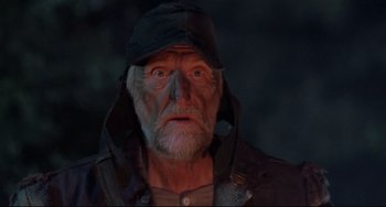 Movie still from “The Blob” (1988), directed by Chuck Russell – An old man wearing a black hat and a black jacket; Close Up shot, Low angle