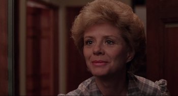 Movie still from “The Blob” (1988), directed by Chuck Russell – An older woman is looking into the camera; Close Up shot, Over the shoulder angle