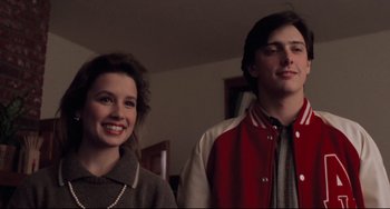 Movie still from “The Blob” (1988), directed by Chuck Russell – A man and a woman standing next to each other in a room; Medium shot, Low angle