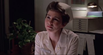 Movie still from “The Blob” (1988), directed by Chuck Russell – A woman wearing a nurse's uniform and a hat; Close Up shot, Low angle