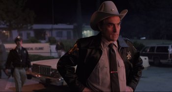 Movie still from “The Blob” (1988), directed by Chuck Russell – A man in a cowboy hat and a leather jacket; Medium shot, Low angle