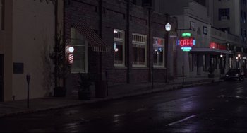Movie still from “The Blob” (1988), directed by Chuck Russell – A street view of a restaurant at night; Extreme Wide shot, Low angle