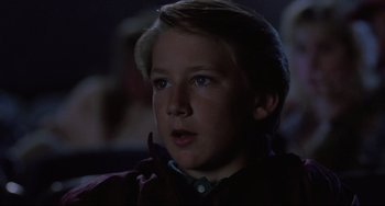 Movie still from “The Blob” (1988), directed by Chuck Russell – A young boy with blonde hair stares into the distance; Close Up shot, Low angle