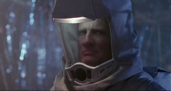 Movie still from “The Blob” (1988), directed by Chuck Russell – A man wearing a space suit and a helmet; Close Up shot, Low angle