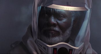 Movie still from “The Blob” (1988), directed by Chuck Russell – An old man with a beard and a helmet on; Close Up shot, Low angle