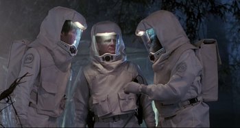 Movie still from “The Blob” (1988), directed by Chuck Russell – A group of people in white suits and helmets; Medium shot, Low angle