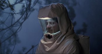 Movie still from “The Blob” (1988), directed by Chuck Russell – A man wearing a protective suit and a hood; Medium shot, Low angle