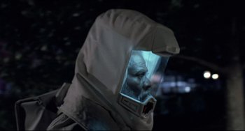 Movie still from “The Blob” (1988), directed by Chuck Russell – A man wearing a protective suit and a helmet; Close Up shot, Over the shoulder angle