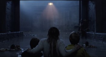 Movie still from “The Blob” (1988), directed by Chuck Russell – A woman and two children watching a light in the sky; Wide shot, Over the shoulder angle