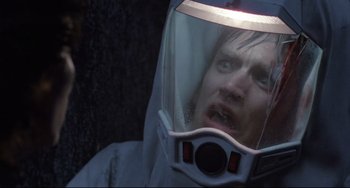 Movie still from “The Blob” (1988), directed by Chuck Russell – A man wearing a white suit and a white helmet; Close Up shot, Low angle