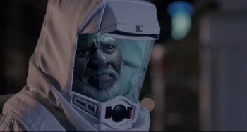 Movie still from “The Blob” (1988), directed by Chuck Russell – An old man wearing a space suit and a helmet; Close Up shot, Over the shoulder angle