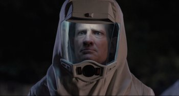 Movie still from “The Blob” (1988), directed by Chuck Russell – A man wearing a space suit and a helmet; Close Up shot, Low angle
