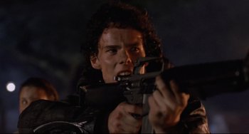 Movie still from “The Blob” (1988), directed by Chuck Russell – A man holding a gun in his hands; Close Up shot, Low angle