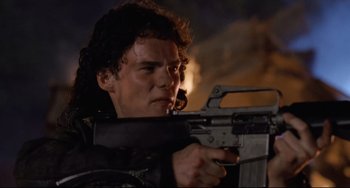 Movie still from “The Blob” (1988), directed by Chuck Russell – A man holding a gun while standing in the dark; Close Up shot, Low angle