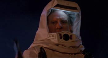 Movie still from “The Blob” (1988), directed by Chuck Russell – A man in a space suit is wearing a helmet; Close Up shot, Low angle