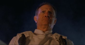 Movie still from “The Blob” (1988), directed by Chuck Russell – A person wearing a white shirt; Close Up shot, Low angle