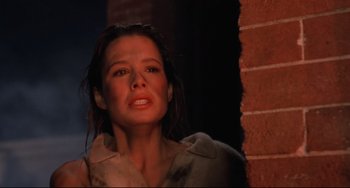 Movie still from “The Blob” (1988), directed by Chuck Russell – A person near a brick wall; Close Up shot, Low angle