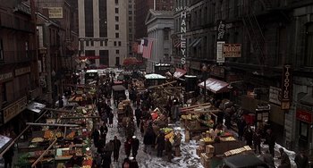 Movie still from “The Brink's Job” (1978), directed by William Friedkin – A busy street filled with lots of people and fruits; Extreme Wide shot, High angle