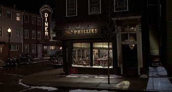 Movie still from “The Brink's Job” (1978), directed by William Friedkin – A restaurant called phillies is lit up at night; Extreme Wide shot, High angle
