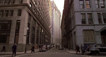 Movie still from “The Brink's Job” (1978), directed by William Friedkin – A city street filled with lots of cars and buildings; Extreme Wide shot, High angle