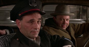 Movie still from “The Brink's Job” (1978), directed by William Friedkin – Two men sitting in the back seat of a car; Close Up shot, Low angle