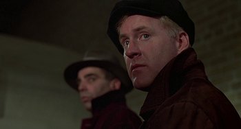 Movie still from “The Brink's Job” (1978), directed by William Friedkin – Two men wearing hats and jackets looking at the camera; Close Up shot, Low angle