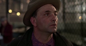 Movie still from “The Brink's Job” (1978), directed by William Friedkin – A person wearing a hat; Close Up shot, Low angle