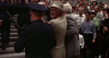 A group of men standing next to each other in front of a crowd of onlookers