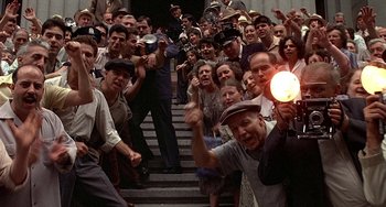 Movie still from “The Brink's Job” (1978), directed by William Friedkin – A group of people standing on some steps; Wide shot, High angle