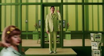 Movie still from “The Cat in the Hat” (2003), directed by Bo Welch – A man in a green suit standing in front of a green wall; Wide shot, Over the shoulder angle