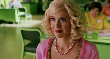 Movie still from “The Cat in the Hat” (2003), directed by Bo Welch – A woman with blonde hair wearing a pink shirt and a pink necklace; Close Up shot, Over the shoulder angle