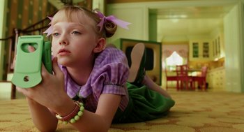 Movie still from “The Cat in the Hat” (2003), directed by Bo Welch – A little girl laying on the floor in a living room; Close Up shot, High angle