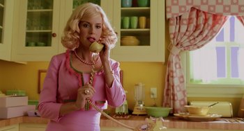Movie still from “The Cat in the Hat” (2003), directed by Bo Welch – A woman in a pink dress talking on a phone; Medium shot, Low angle