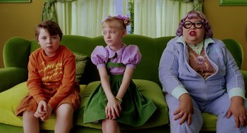 Movie still from “The Cat in the Hat” (2003), directed by Bo Welch – Three people sitting on a green couch; Medium shot, High angle