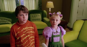 Movie still from “The Cat in the Hat” (2003), directed by Bo Welch – Two young children standing next to each other in a living room; Close Up shot, High angle