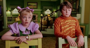 Movie still from “The Cat in the Hat” (2003), directed by Bo Welch – Two children sitting in chairs in a living room; Medium shot, Over the shoulder angle