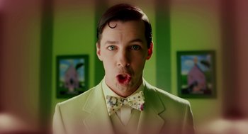 Movie still from “The Cat in the Hat” (2003), directed by Bo Welch – A man in a suit and bow tie making a funny face; Close Up shot, Low angle