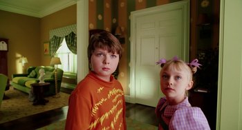 Movie still from “The Cat in the Hat” (2003), directed by Bo Welch – Two young children standing next to each other in front of a door; Close Up shot, High angle