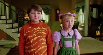 Movie still from “The Cat in the Hat” (2003), directed by Bo Welch – Two young children dressed up for halloween posing for a picture; Medium shot, High angle