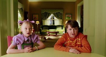 Movie still from “The Cat in the Hat” (2003), directed by Bo Welch – Two children sitting at a table in a living room; Medium shot, High angle