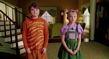 Movie still from “The Cat in the Hat” (2003), directed by Bo Welch – Two children standing next to each other in a living room; Medium shot, High angle