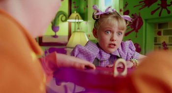 Movie still from “The Cat in the Hat” (2003), directed by Bo Welch – A little girl in a purple dress is looking at the camera; Close Up shot, Over the shoulder angle